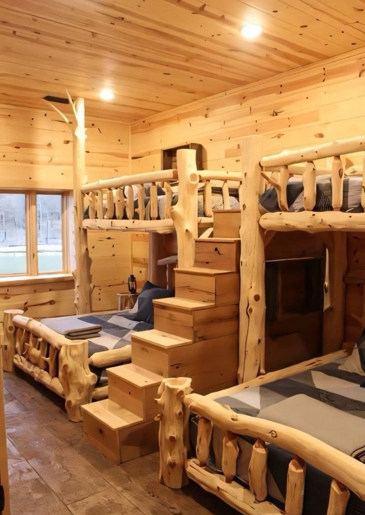 Timber estate bunkroom with hand-scribed log walls and built-in berths for family stays