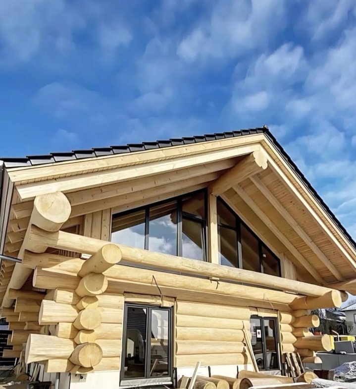 Hand-scribed timber estate with modern gable architecture at dusk, New Zealand