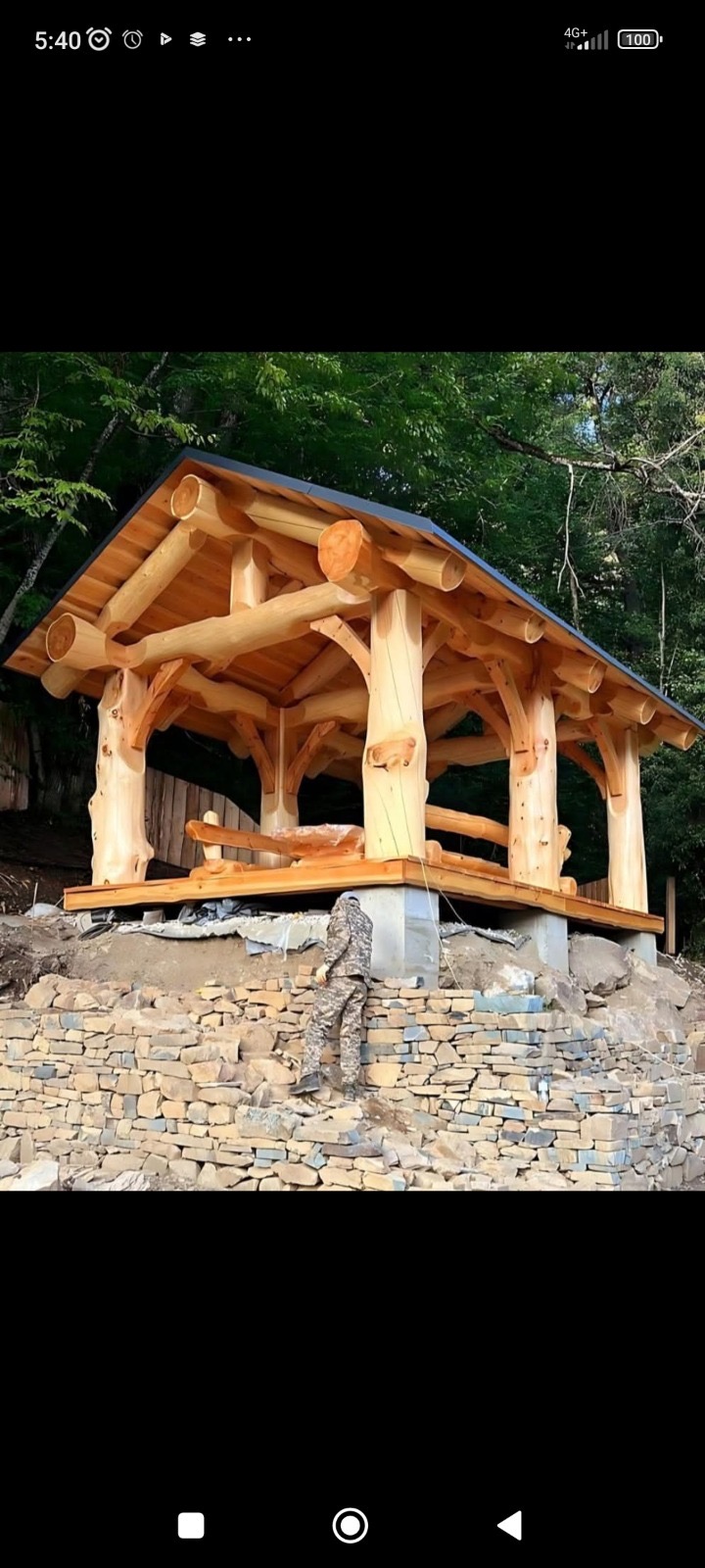 Hand-scribed timber gazebo with heavy log posts in a New Zealand garden setting