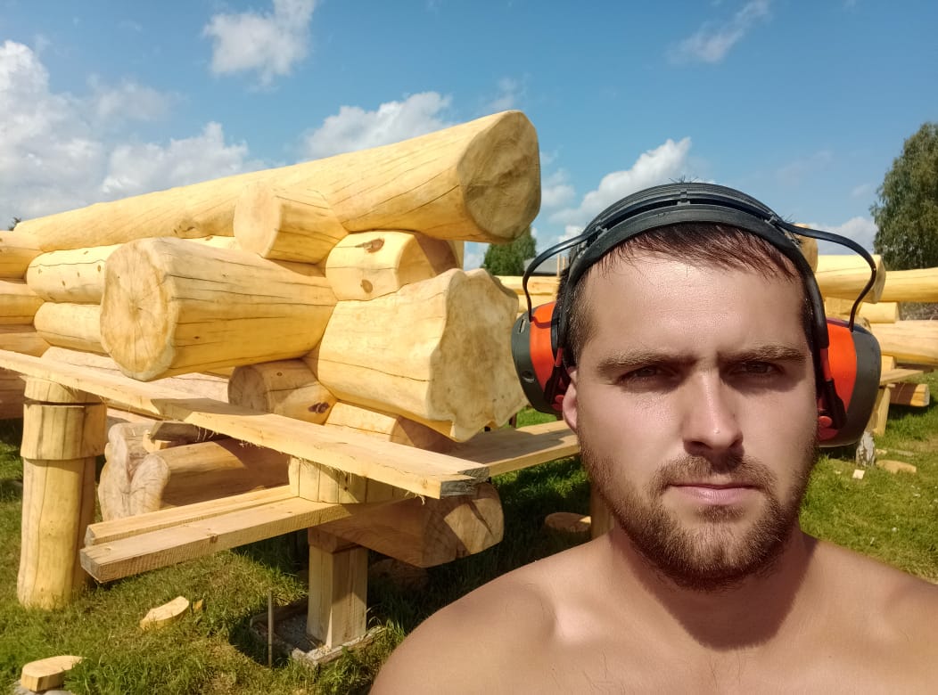 Master craftsman Ilia Zubko hand-scribing timber in warmer months
